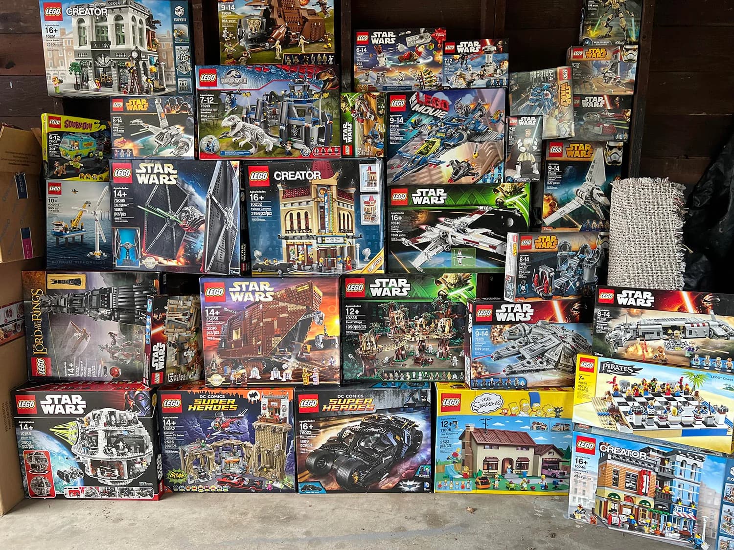 A collection of LEGO boxes. The Palace Cinema box numbered 10232 is visible near the center.